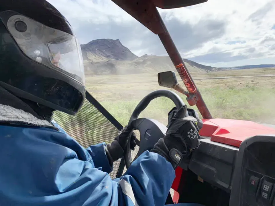 Driver's view from inside a buggy with a mountain ahead