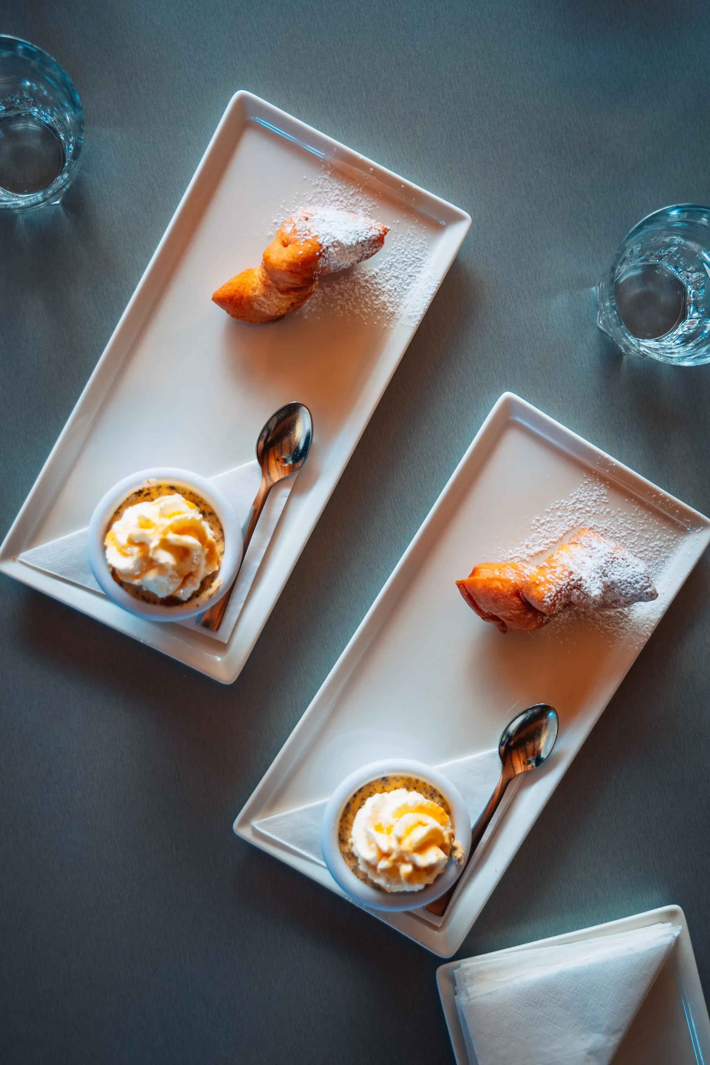 Two plated Icelandic desserts on a dark table