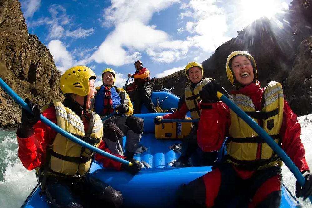 Smiling rafters in helmets and life jackets